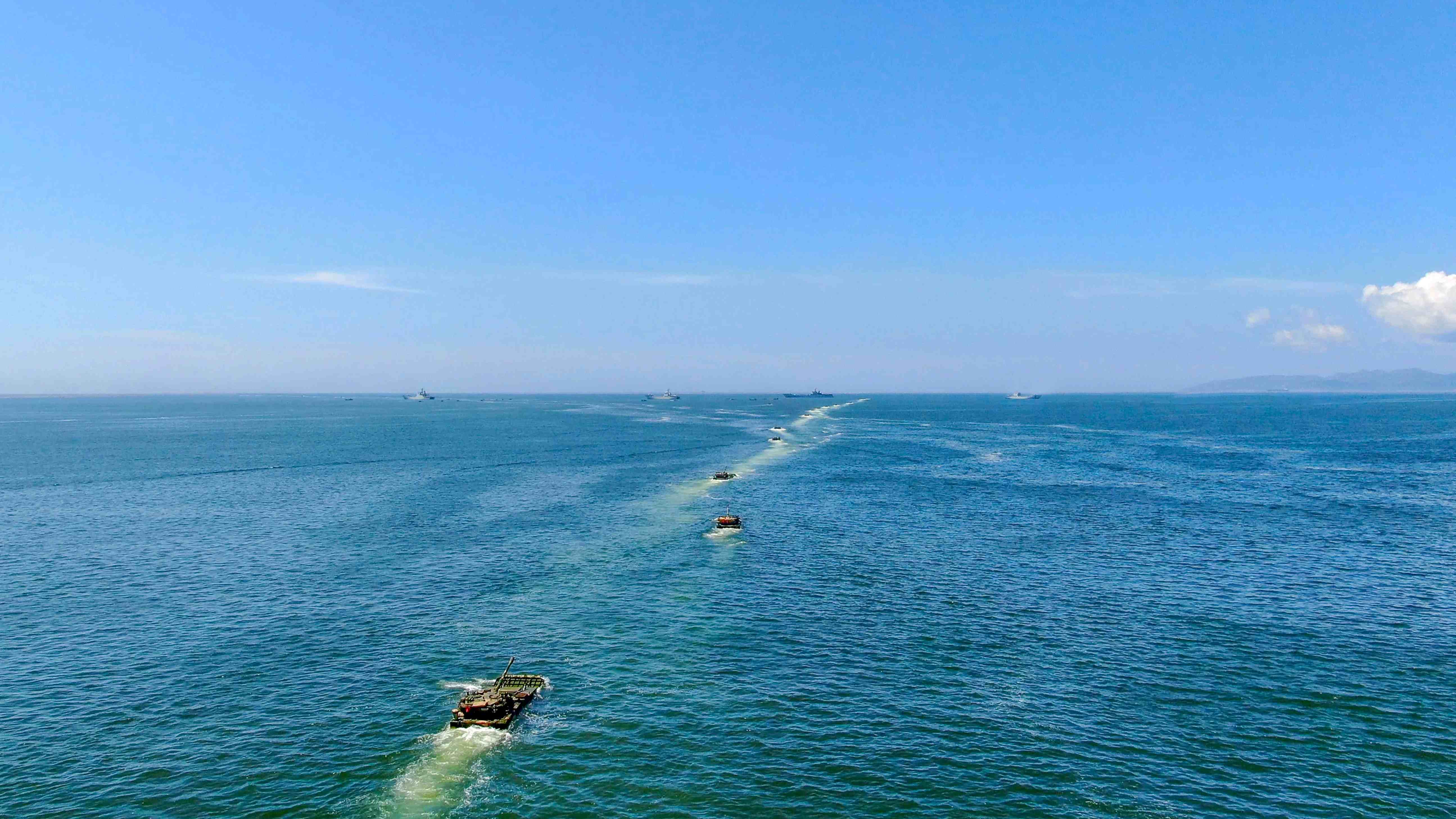 Amphibious armored vehicles maneuver in formation