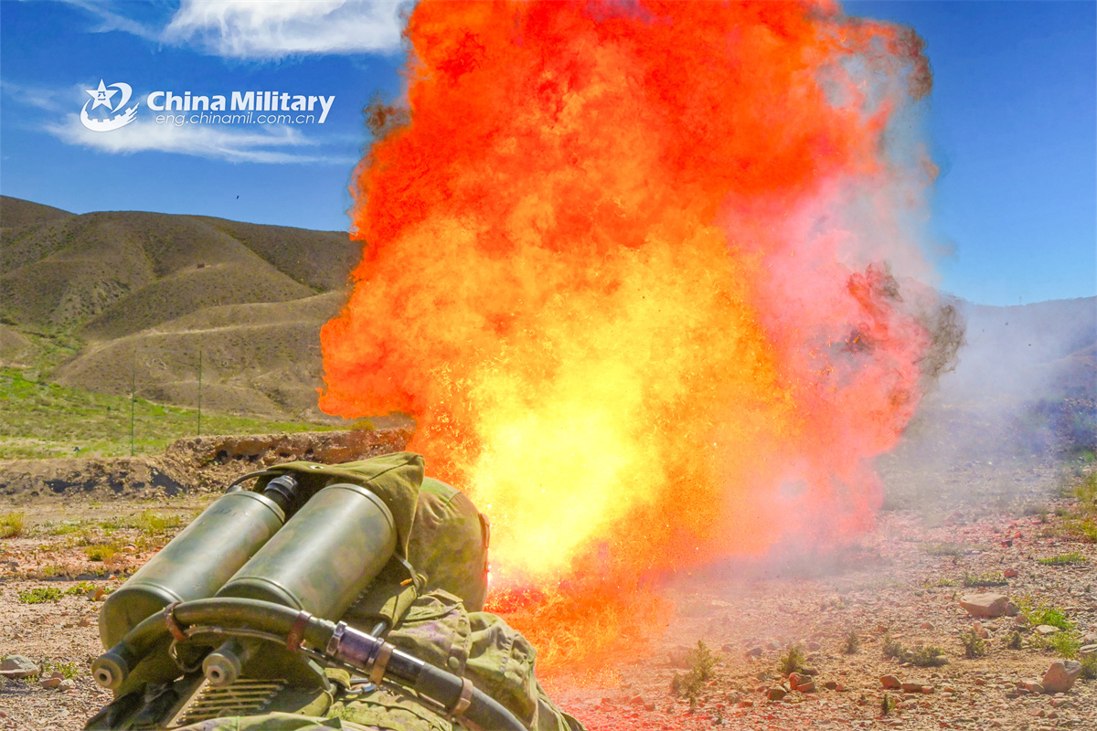 Soldiers shoot with flamethrower